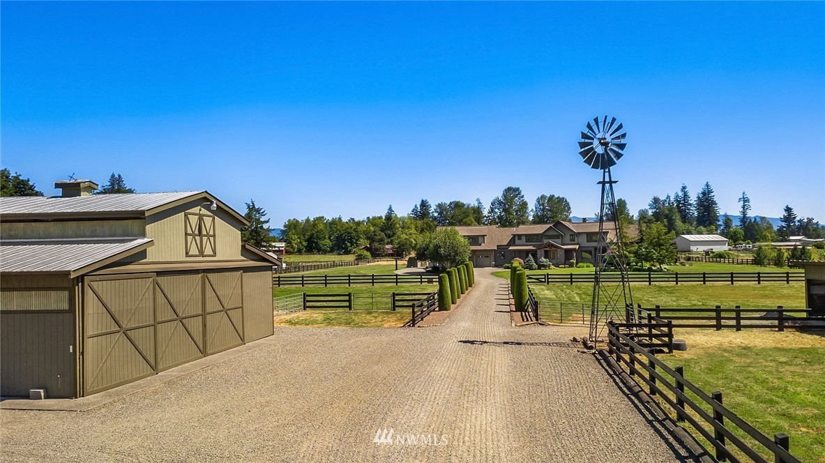 The Wabash Aussies grounds with a barn, fenced fields and a windmill